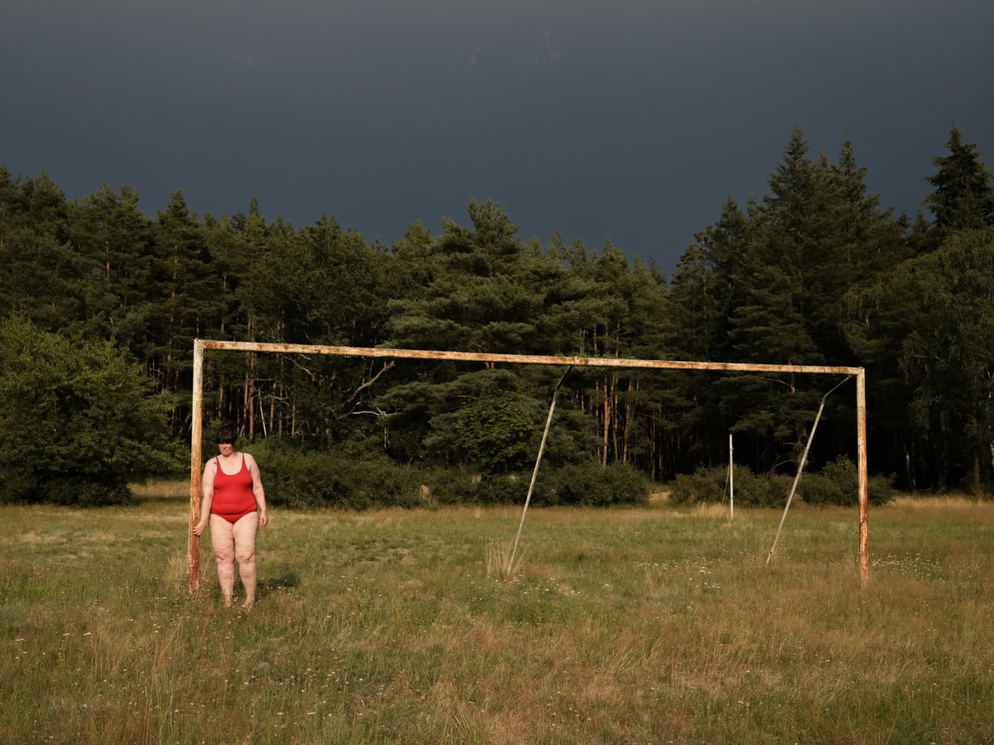 Self-portrait in front of a football goal